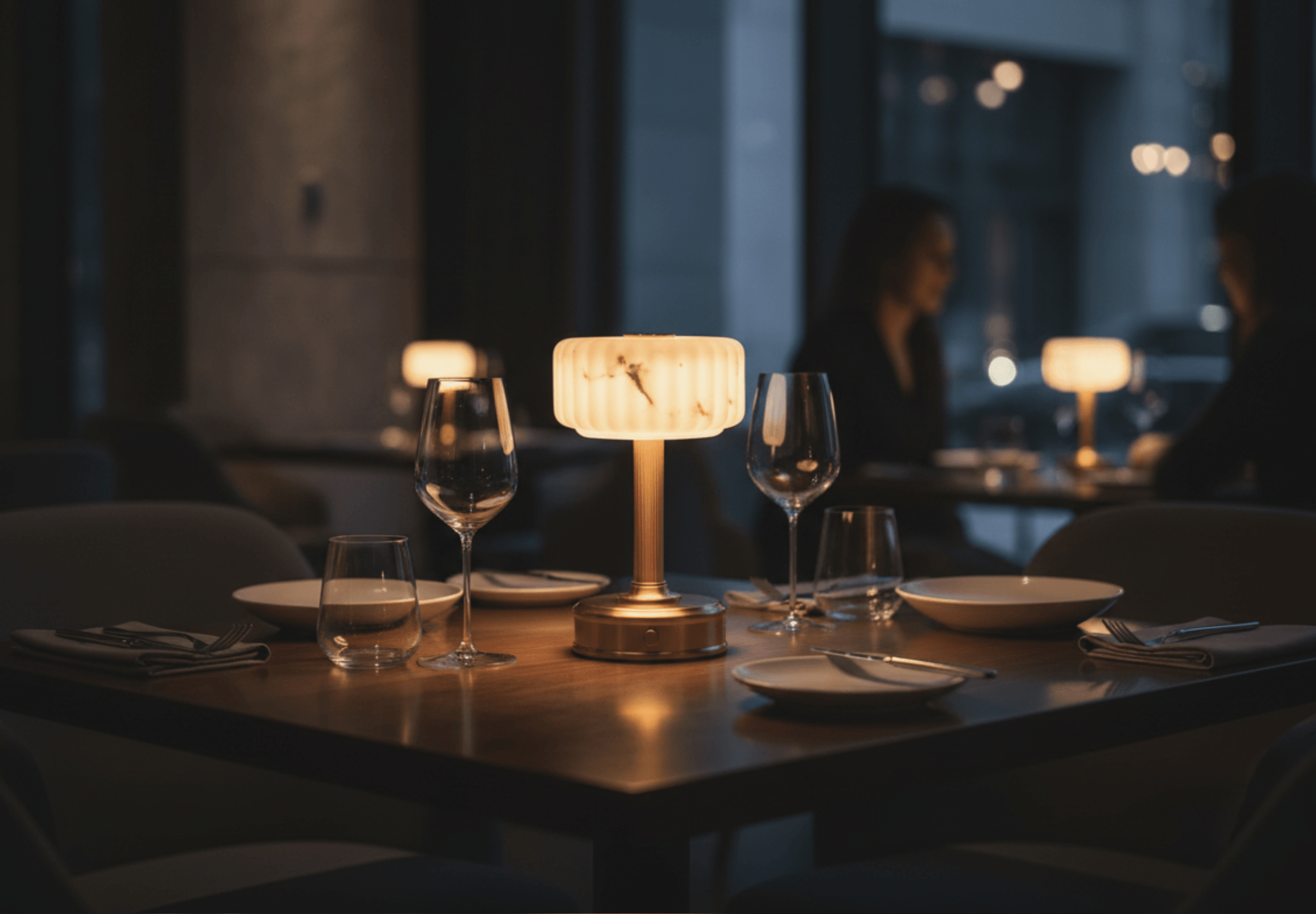 Dining table setting with a rechargeable modern lantern Milo lamp and wine glas