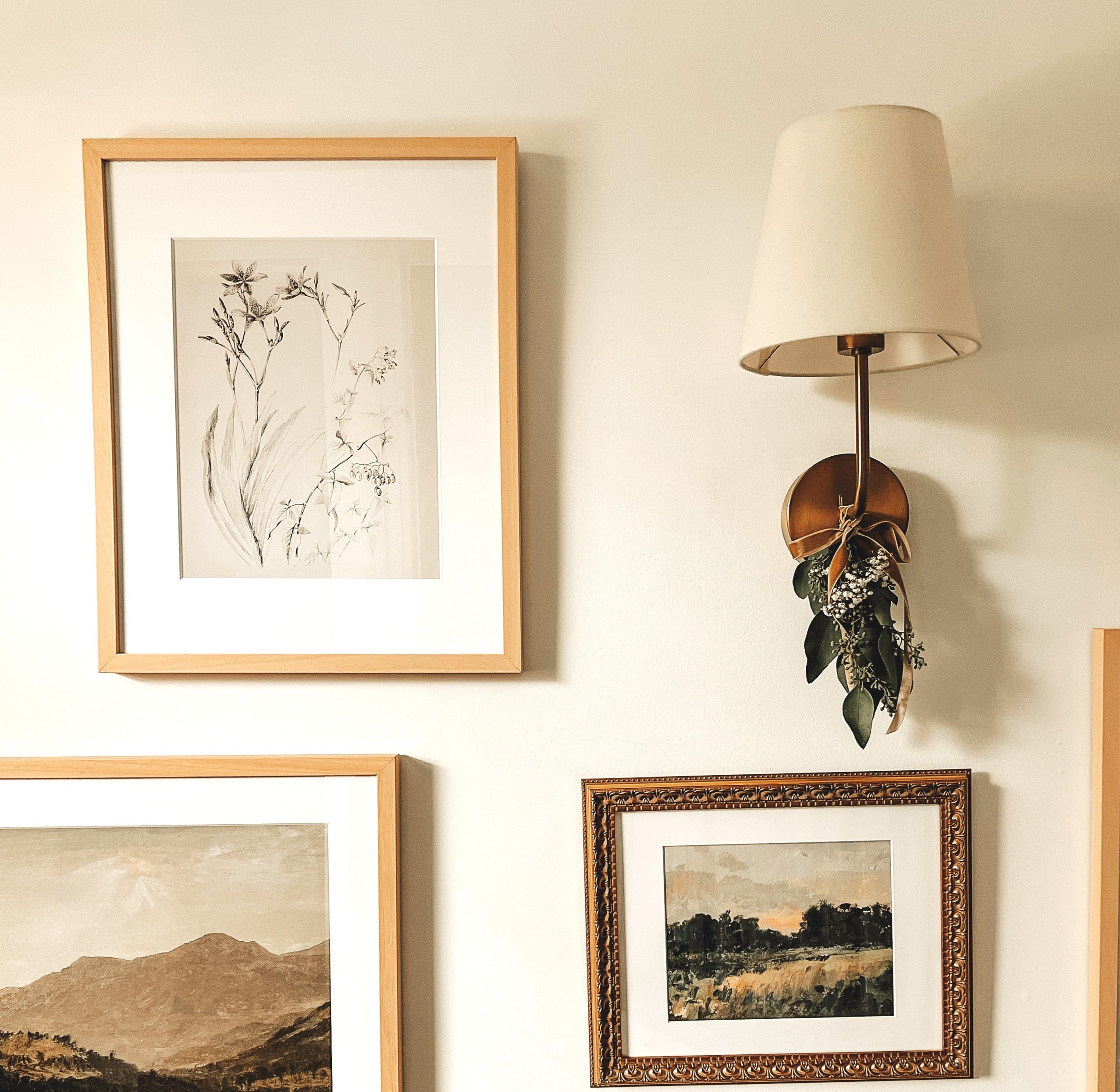 Decor Cordless Wall Sconce - Emily Rechargeable Lamp illuminating art-filled wall decor.