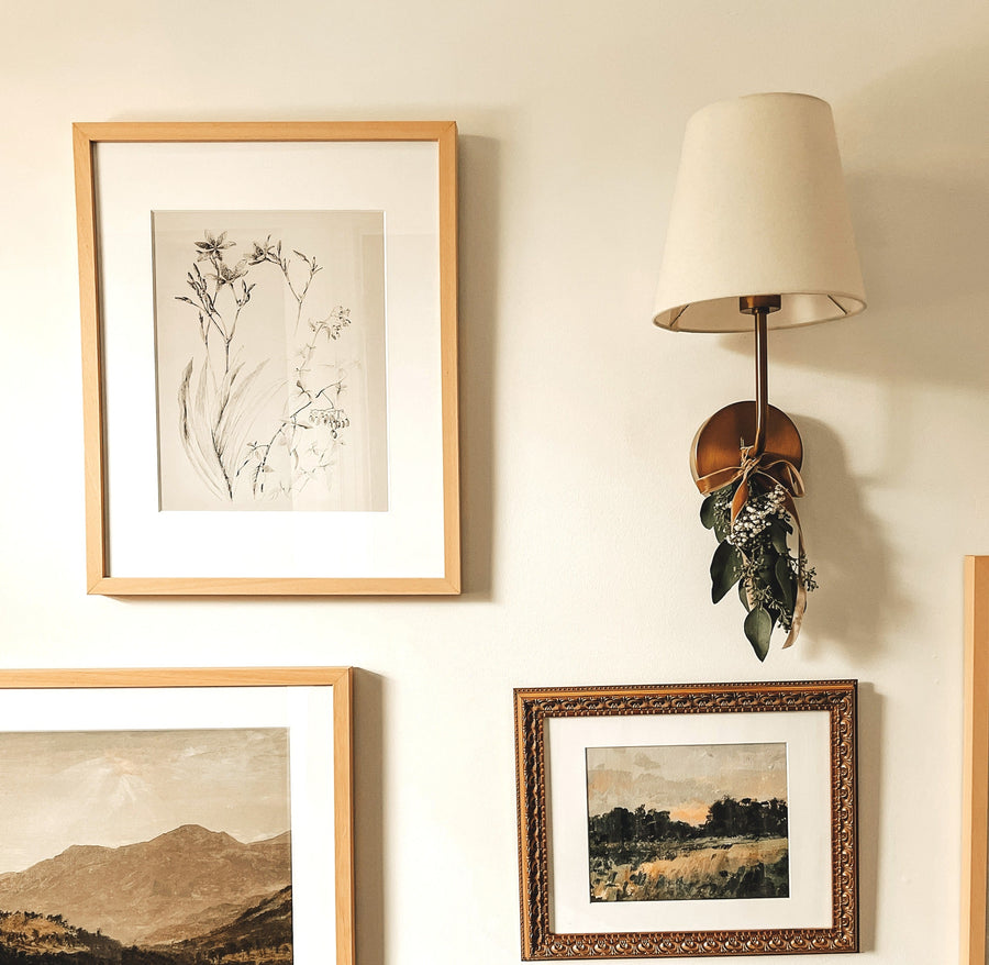 Decor Cordless Wall Sconce - Emily Rechargeable Lamp illuminating art-filled wall decor.