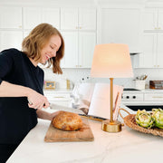 Cordless brass adjustable mini lamp in kitchen setting