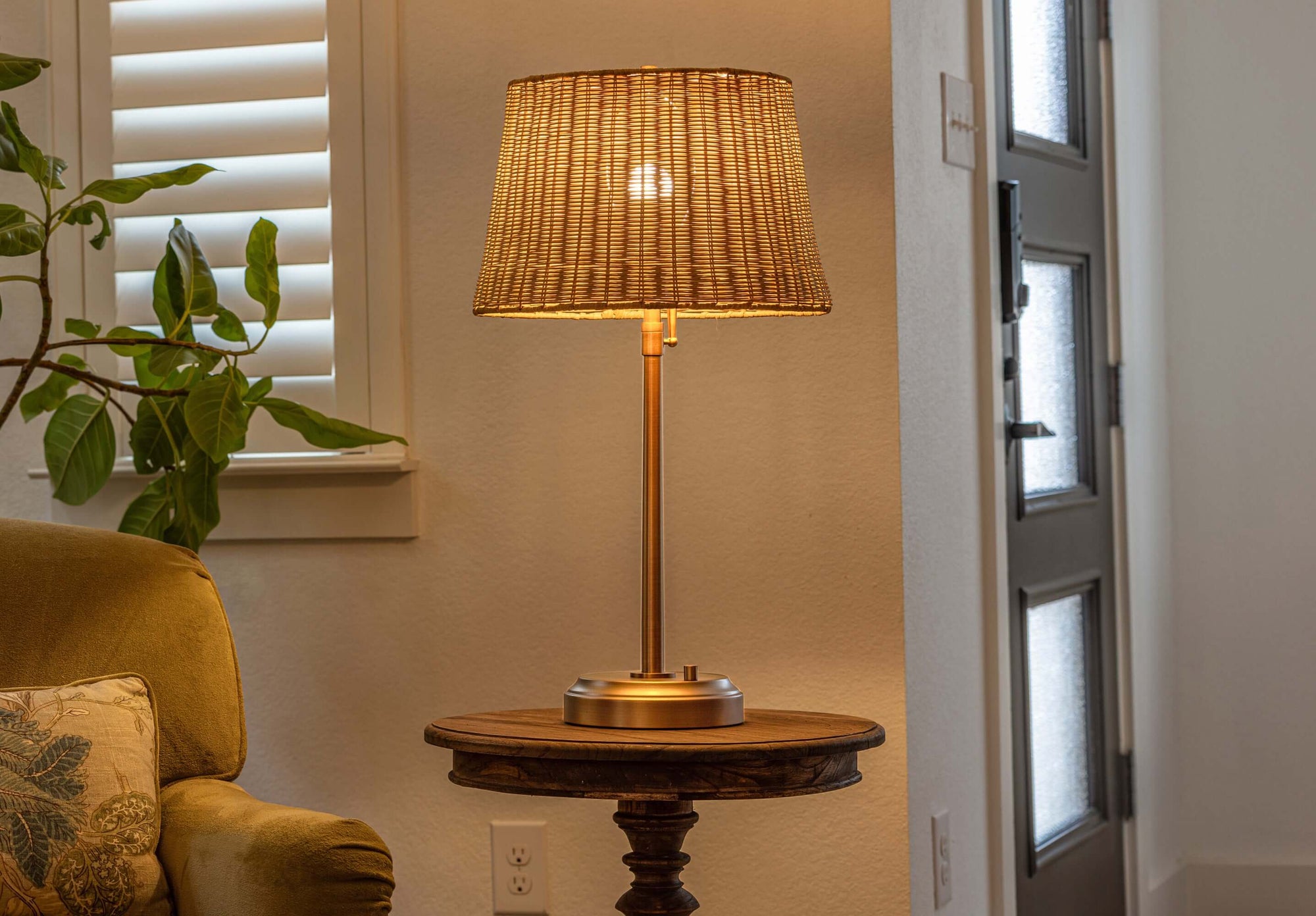 alexis adjustable cordless table lamp in brass with rattan shade