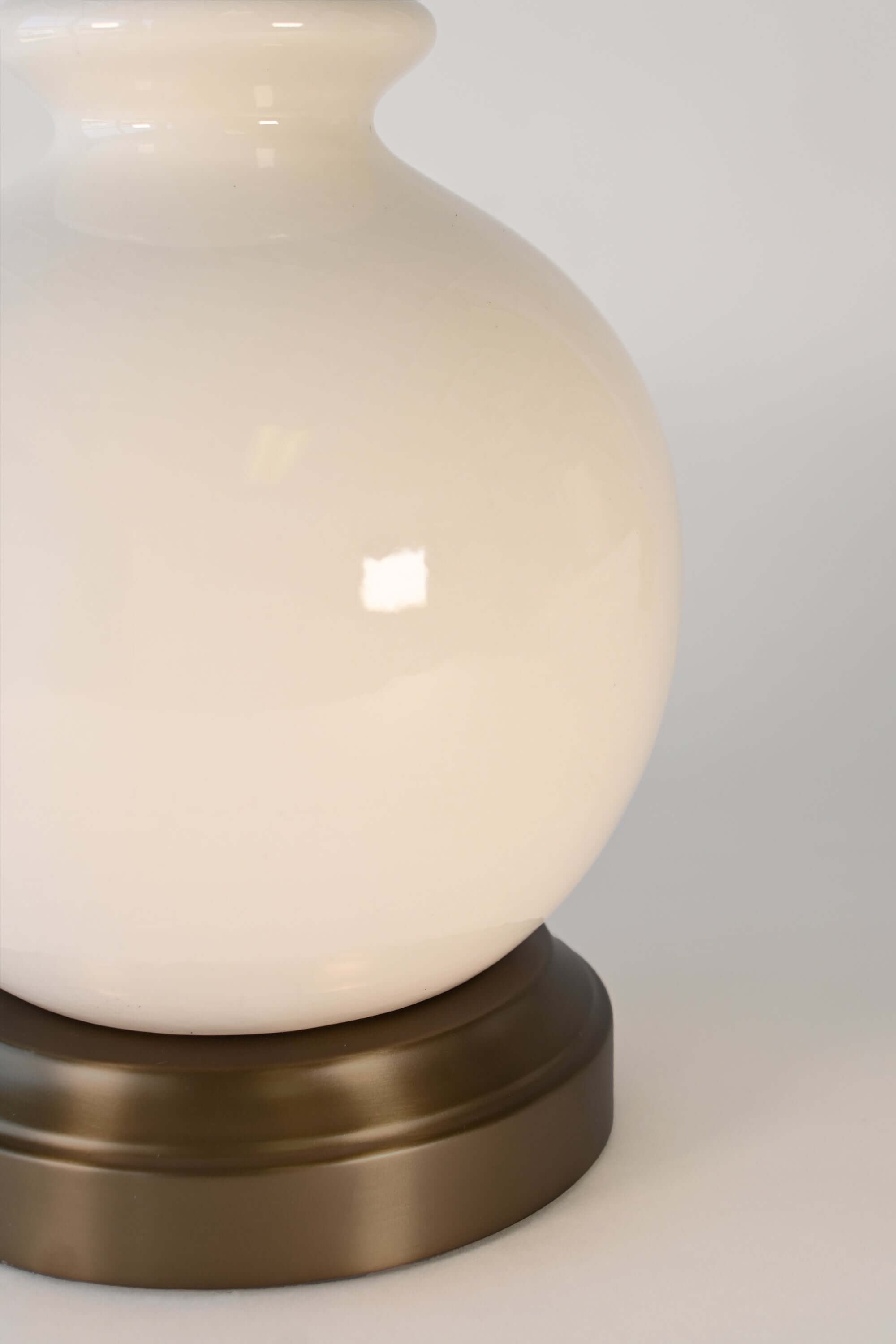 detail shot of made in America ceramic lamp body in ivory on black metal base