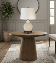 Wooden side table with abbeygale on black cordless lamp in a entry room setting