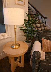 OPEN BOX Alexis Cordless Table Lamp on a wooden side table next to a cozy couch in a well-lit living room.