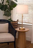 Decorative brass cordless lamp on a wooden side table by modern lantern