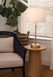 Decorative brass cordless lamp on a wooden side table by modern lantern