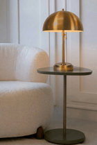 adjustable brass cordless table lamp on a side table modern design