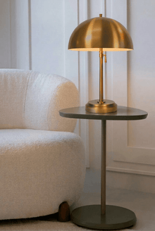adjustable brass cordless table lamp on a side table modern design