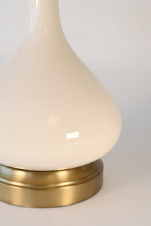 Close-up of a cordless lamp with ivory ceramic and brass base