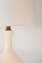 Close-up of a ivory ceramic lamp with a off white shadebackground