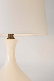 Close-up of a ivory ceramic lamp with a off white shadebackground