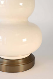 close up of modern lantern ceramic lamp on dark brass