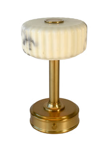Cordless mini table lamp with marble-like shade and gold base that is battery operated