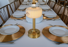 Dining table setting with brass battery lamp