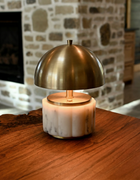 nora brass cordless mini lamp in center wood table