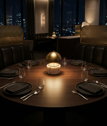 Nora cordless mini lamp with brass shade in center of luxury dining atmosphere