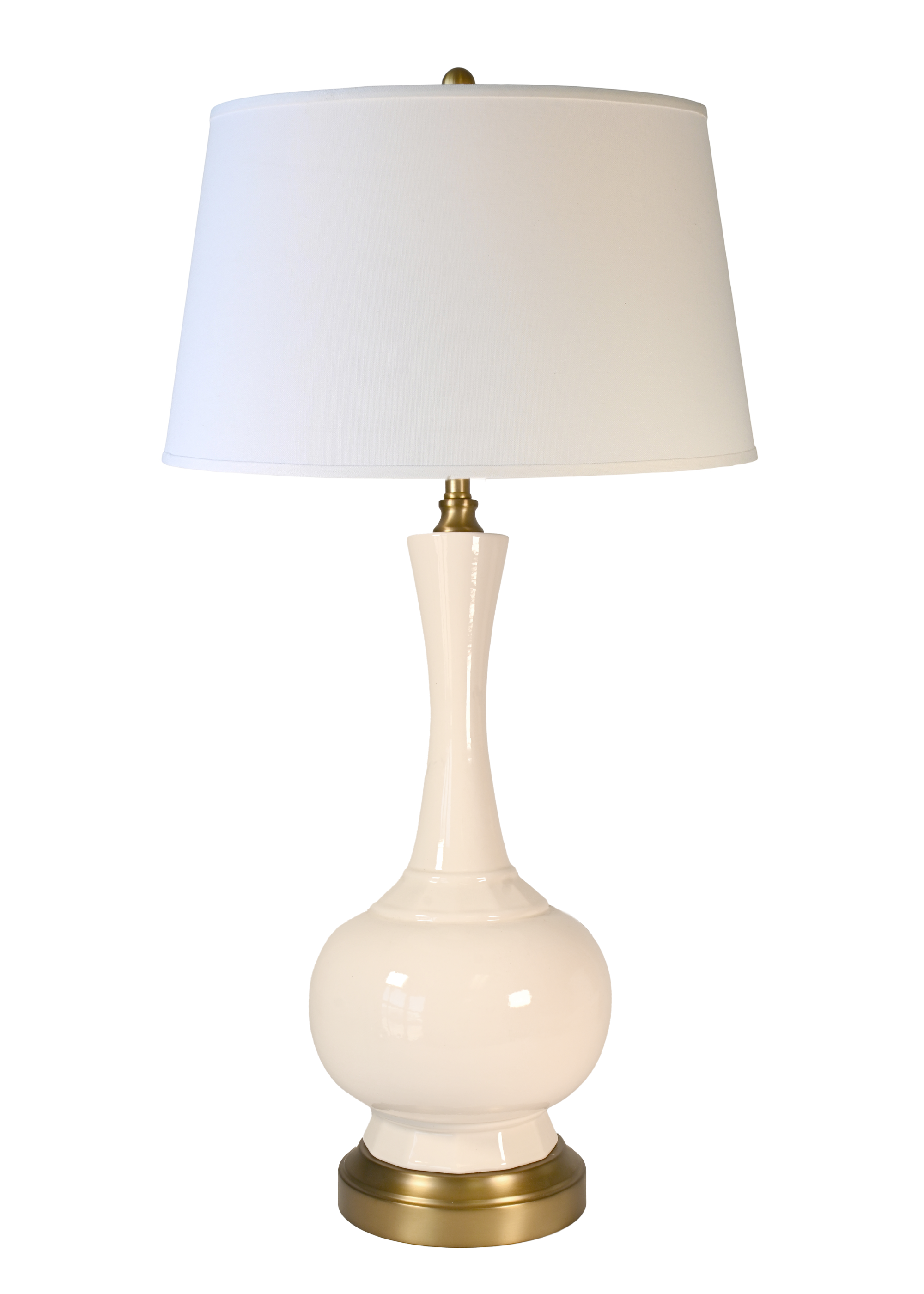 A cordless table lamp with a glossy cream ceramic base, an off white fabric linen shade, and brass-finished metal accents at the neck and base.